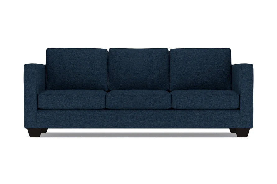 The Catalina Sofa is a dark blue, three-seater with a clean, modern design. It features three cushions and straight arms, set on short black legs, against a plain white background.