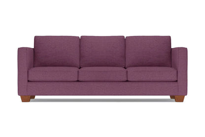 The Catalina Sofa, a plum-colored three-seater with wide armrests and wooden legs, is set against a plain white background. It features three plush seat and back cushions.