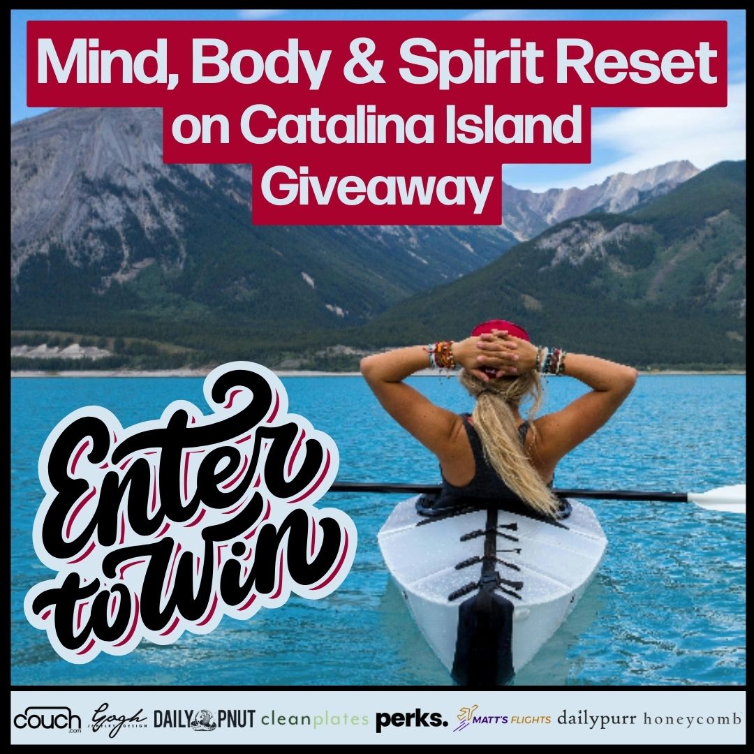A woman in a black swimsuit is sitting on a paddleboard in a calm, blue lake with mountains in the background. Text at the top reads "Mind, Body & Spirit Reset on Catalina Island Giveaway." At the bottom, a large "Enter to Win" is written in stylish font. Various brand logos are displayed at the bottom.