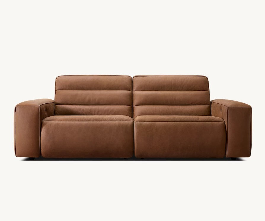 The Chelsea Motion Leather Modular 2-Piece Recliner Sofa is a modern brown leather sofa with prominent armrests, displayed against a plain white background.