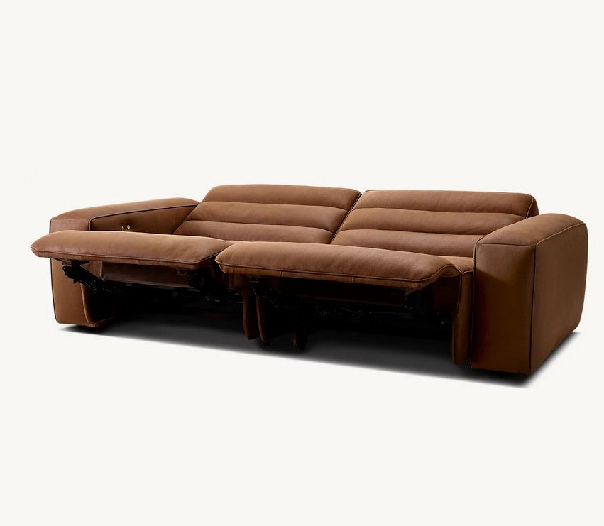 The Chelsea Motion Leather Modular 2-Piece Recliner Sofa, made of brown leather with cushioned seats and wide armrests, is shown in a reclined position. It features a modern design and is set against a plain white background.