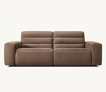 The Chelsea Motion Leather Modular 2-Piece Recliner Sofa, featuring a brown leather finish with plush cushions and wide armrests, is centered against a plain white background. This modern, minimalist design offers two seats for optimal comfort.