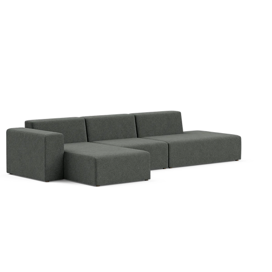 The Three-Seater Form Sectional is a sleek, modern gray sectional sofa featuring a left chaise lounge. It boasts a minimalist design with clean lines and low-profile cushions, providing a contemporary look perfect for a stylish living space.