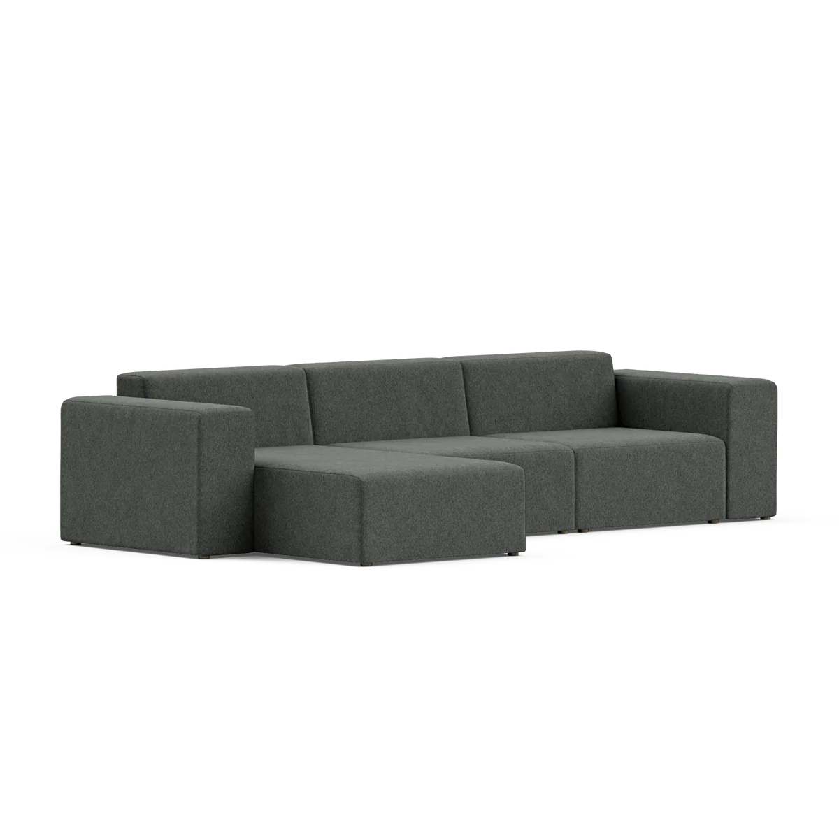 The Three-Seater Form Sectional, featuring a modern dark gray L-shaped design, showcases clean lines with cushioned seats and backrests. Set against a simple backdrop, its minimalistic and contemporary style highlights both comfort and aesthetic appeal.