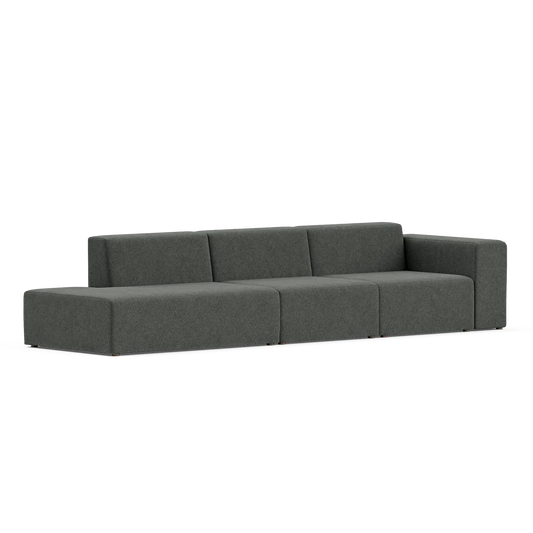 Introducing the Three-Seater Form Sectional, a contemporary piece with a minimalist design featuring dark gray upholstery. It boasts clean lines and block-shaped cushions, complemented by low armrests and a spacious seating area, all showcased against a simple white background.