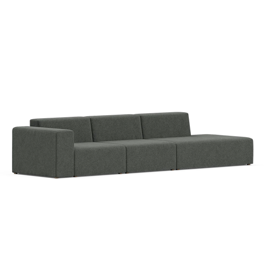 A contemporary, minimalist Three-Seater Form Sectional in dark gray features three cushioned seats and an extended right-side chaise. It showcases clean lines and a low profile against a plain white background.