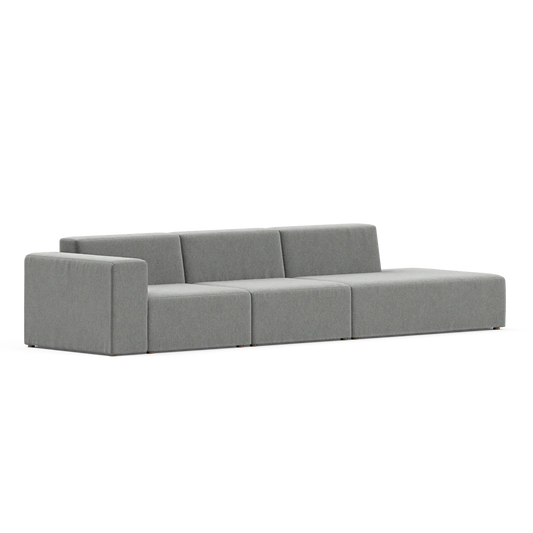 The Three-Seater Form Sectional is a modern, minimalist gray sofa featuring low armrests, elegantly displayed against a plain white background.