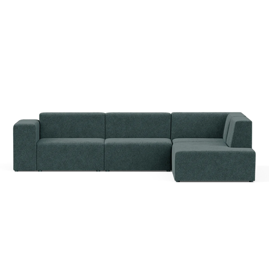 The Four-Seater Form Sectional is a modern, dark teal sectional sofa with a minimalist design. It features a left-hand armrest, three connected seats, and an extended chaise on the right side, positioned against a plain background.