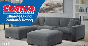 A grey sectional sofa with an ottoman is placed in a modern living room setting. Above the sofa, a graphic overlay reads, "Costco Wholesale: Ultimate Brand Review & Rating" in white text on a blue background. The corner of a "couch.com" logo is visible in the bottom left.