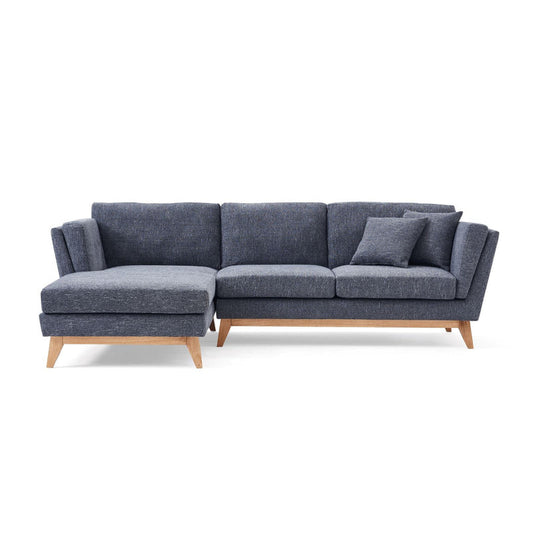 The ValMinimal Sectional is a contemporary dark gray L-shaped sofa featuring wooden legs and comes with a matching throw pillow on one side.