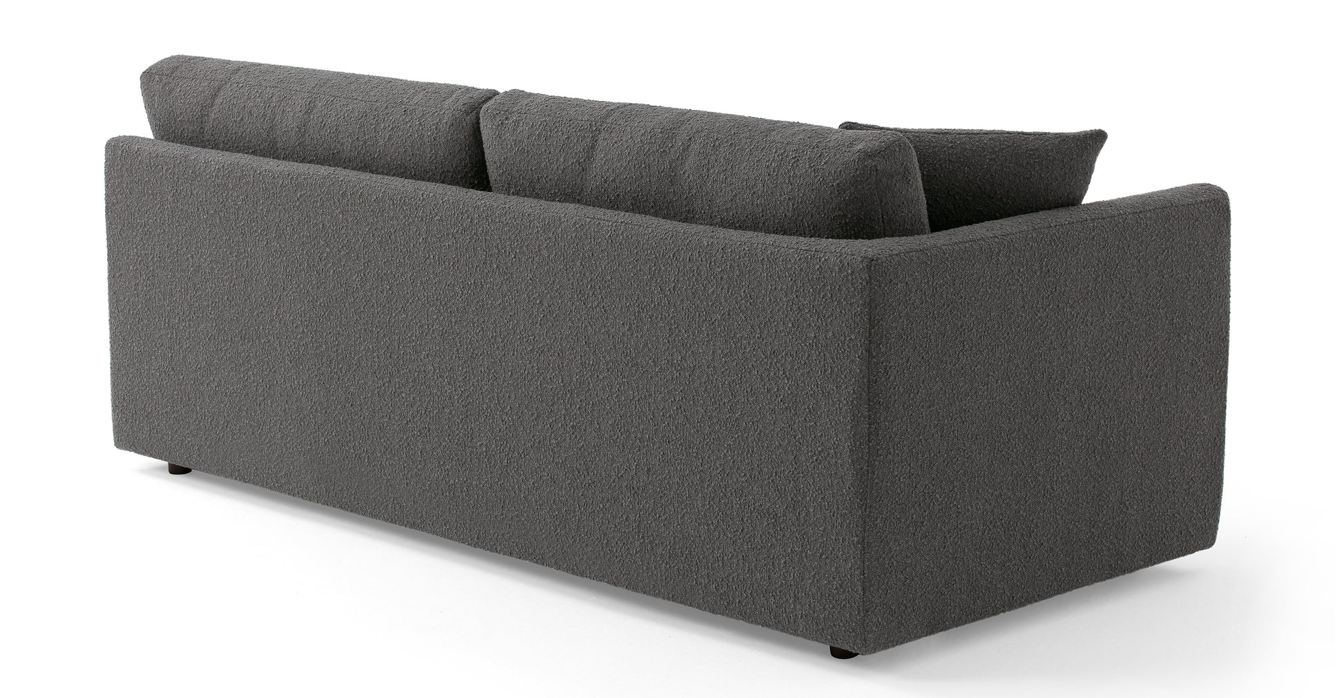 The Domus 74" Left Arm Leather Sofa in Ebony is presented from the back, showcasing a minimalist design with clean lines. It features two large back cushions and is set against a plain, white background.