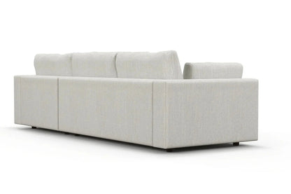 The rear view of the Daphne Chaise 96" Sofa showcases its modern, light gray sectional design with plush cushions and a minimalist aesthetic, set against a white background.