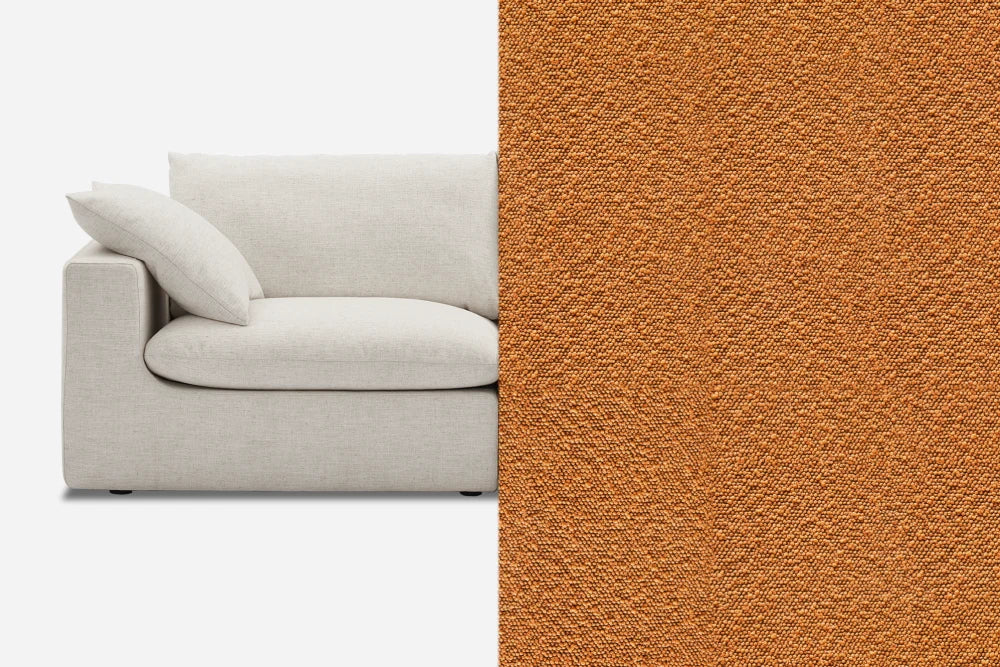 A modern, light beige upholstered sofa is partially visible on the left. The right side displays a close-up of an orange textured fabric, possibly an alternative upholstery option for the sofa.