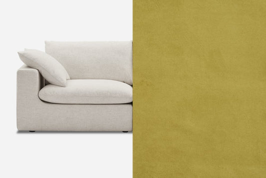 A cream-colored sofa with plush cushions is partially visible on the left side. The right side of the image shows a solid mustard yellow background.