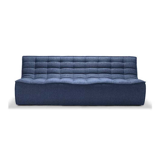 The N701 3 Seater Sofa by Ethnicraft is a contemporary, blue piece featuring a quilted design with a rectangular shape, offering a straightforward, minimalist aesthetic. It boasts a smooth, wave-like seat and a tall back adorned with stitched squares. The sofa is supported by an invisible, low-profile base.