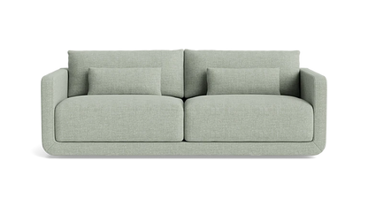 Introducing the Eva 85" Sofa, a modern piece in a light gray hue featuring two spacious seat cushions and two large back cushions. It comes with two smaller matching pillows, showcasing clean lines and a minimalist design against a plain black background.