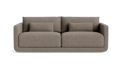 The Eva 85" Sofa is a modern design in brown, featuring two large cushions and two smaller rectangular pillows, set against a plain background.