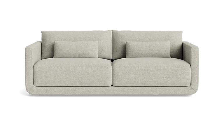 A modern, minimalist two-seater Eva 85" Sofa in beige features clean lines and comes with two matching rectangular cushions on each seat, enhancing its comfortable and stylish look against a black background.