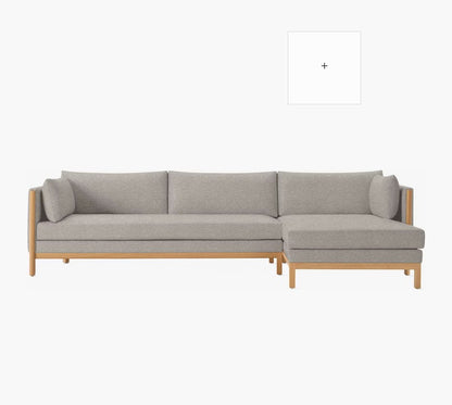 Introducing the Emmy Sectional: A modern gray sofa with wooden legs, complete with a right-side chaise lounge. It boasts a minimalist design and comfortable cushions, set against a plain white background.