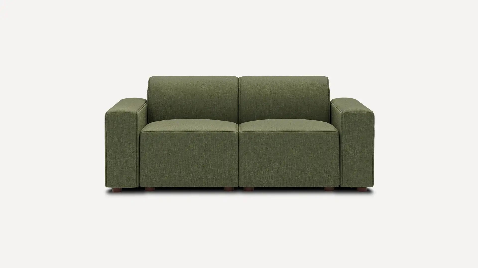 The Mambo Loveseat is a modern, green two-seater sofa featuring a minimalist design with square arms. It is set against a plain white background, showcasing its subtly textured fabric and small dark wooden legs.