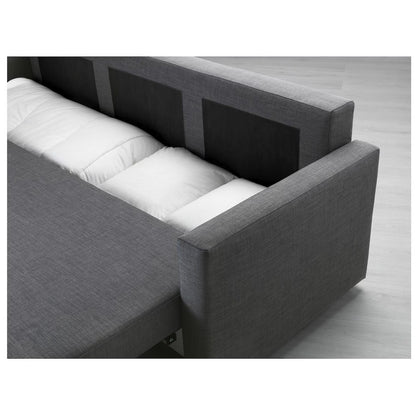 FRIHETEN Sleeper Sofa with the mattress partially unfolded in a modern, light-colored room. The fabric appears textured, and the backrest is upright.