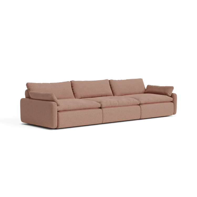 The Sink Down Sectional offers a modern design in beige, featuring three spacious seats with large, plush cushions and armrests on each end. Its simple, clean style makes it ideal for a contemporary living room setting.