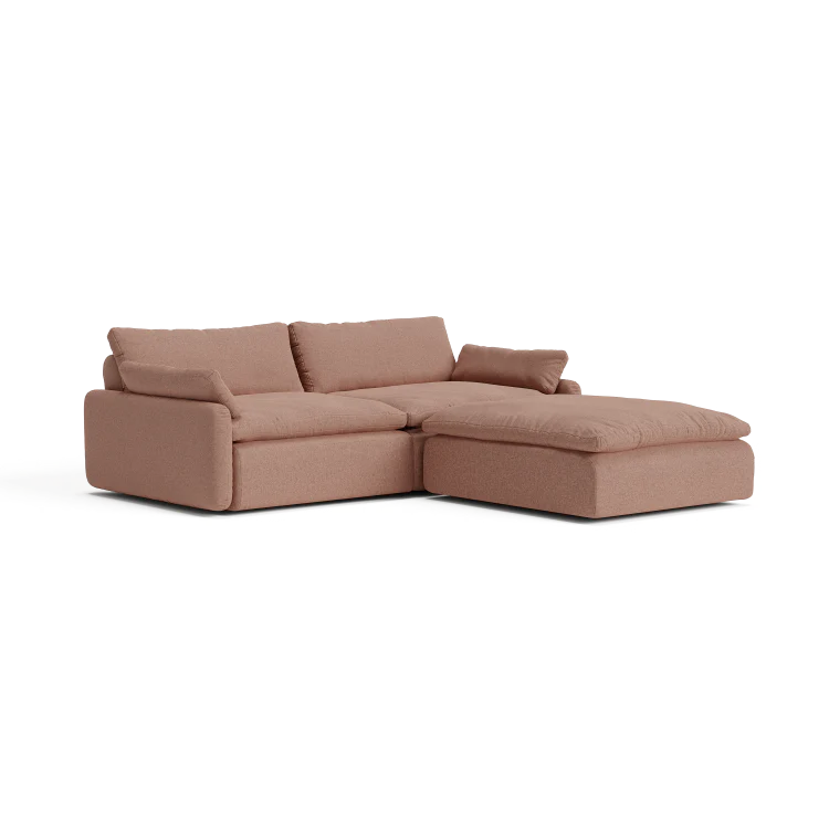 The Sink Down Sectional, a brown sectional sofa with a chaise lounge on the right, features thick cushions and armrests, set against a plain white background.