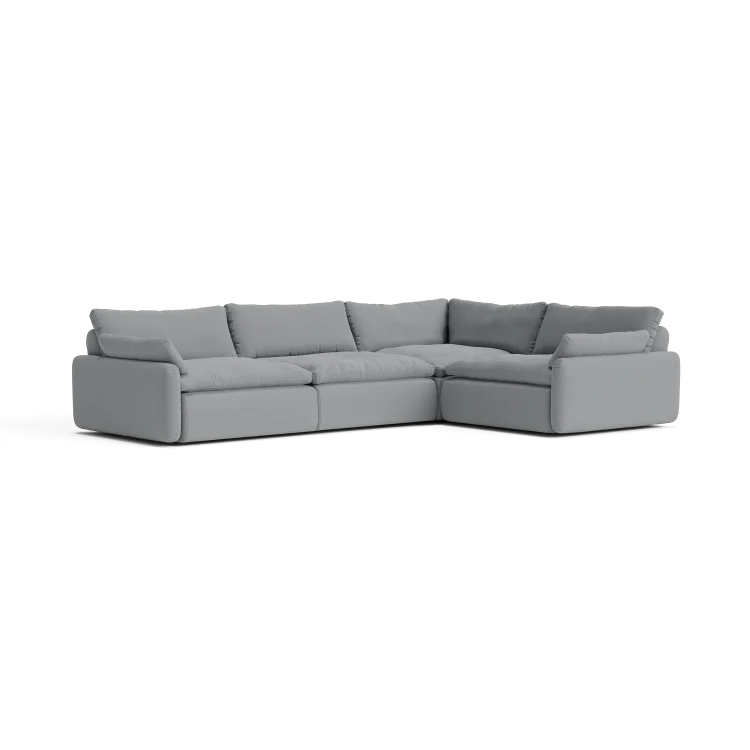 The Sink Down Sectional is a large, gray, L-shaped sofa with thick cushions and a modern design, placed against a plain background.