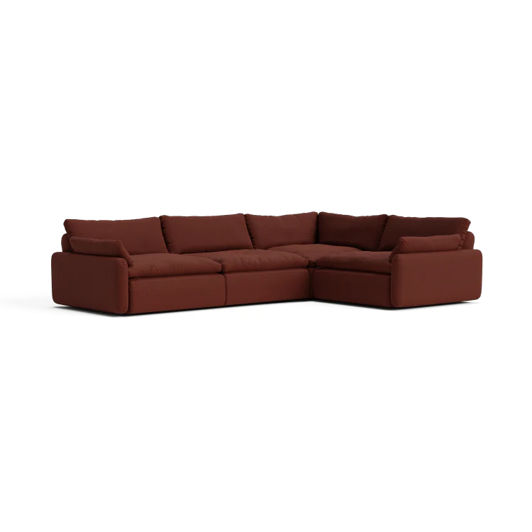 The Sink Down Sectional is a large, L-shaped, brown sofa featuring plush cushions and a low backrest, all set against a white background. Its modern design includes deep seating for enhanced comfort.