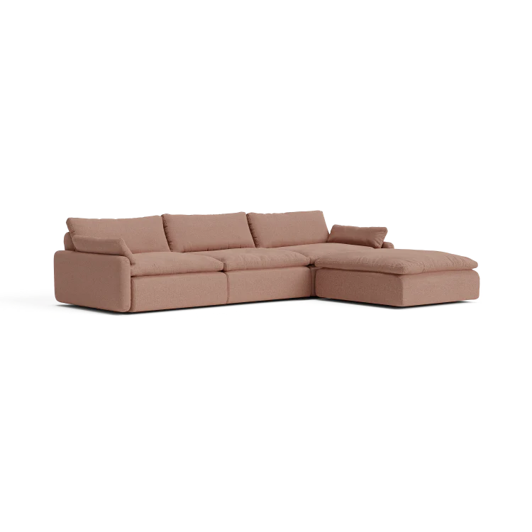 Introducing The Sink Down Sectional: a contemporary L-shaped sofa in a cozy warm brown tone. This sectional boasts a smooth texture, complete with three main seat cushions and an attached chaise on the right side. The plush back cushions provide exceptional comfort for a relaxing seating experience.