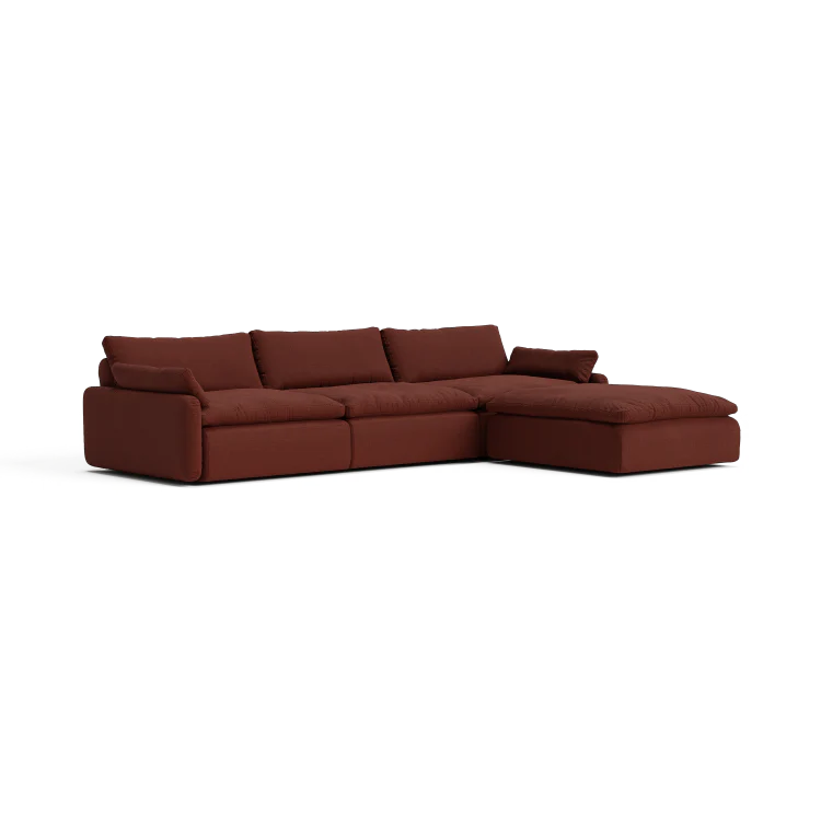 Introducing The Sink Down Sectional – a dark brown sofa featuring plush cushions and a modern design. With its right-side chaise extension, it’s perfect for lounging and relaxation.