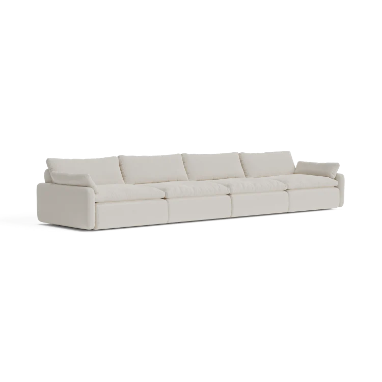 The Sink Down Sectional is a long, modern sectional sofa with a white fabric finish, featuring multiple cushions and a minimalist design, set against a plain background.