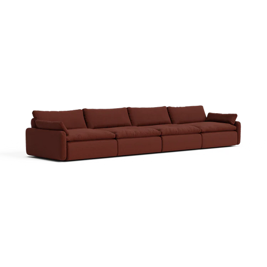 The Sink Down Sectional is a contemporary, extended sofa with a luxurious deep brown fabric finish. It consists of five interconnected seats, complete with plush backrests and armrests at both ends, showcased against a clean white backdrop.