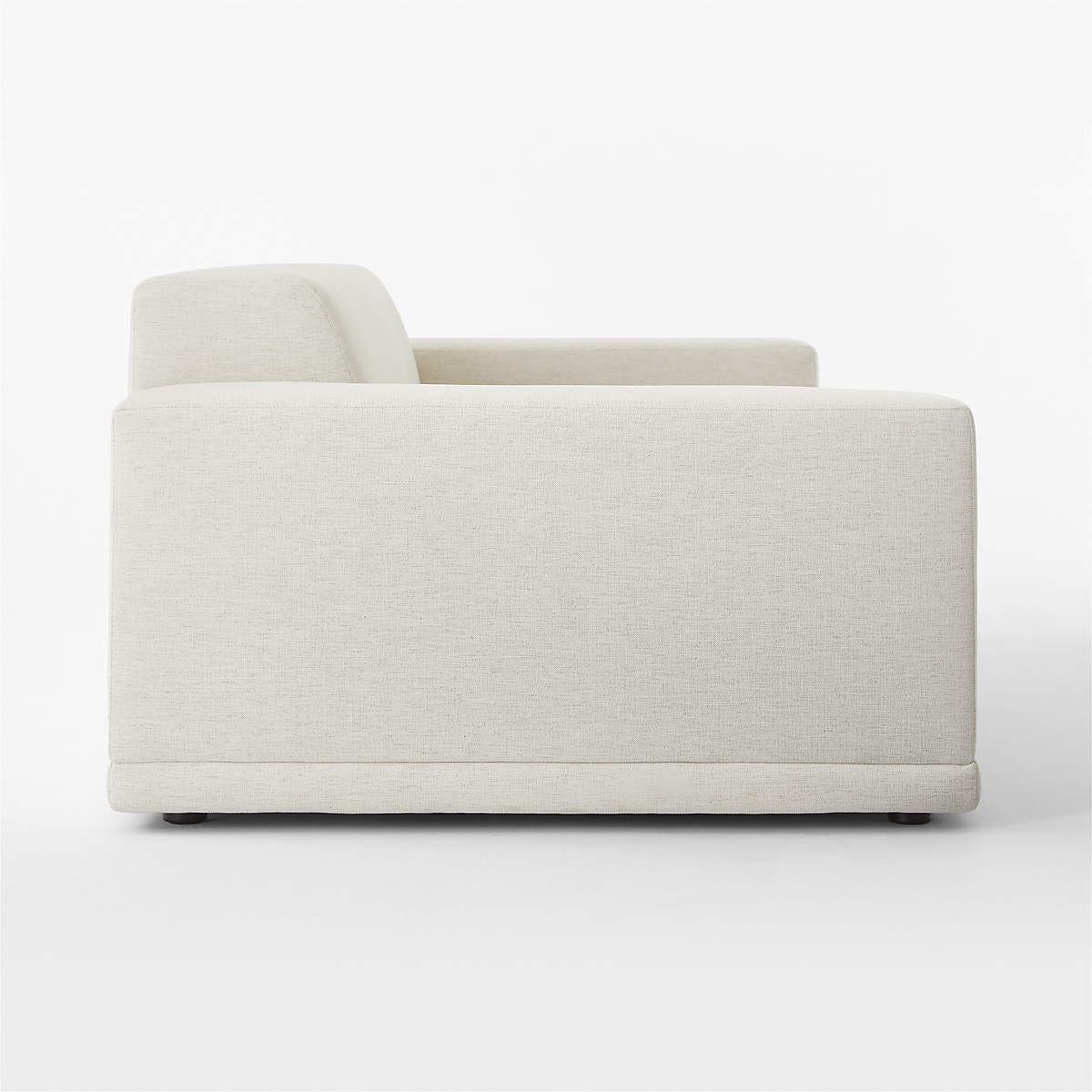 Side view of the Faible 100" White Performance Fabric Sofa against a white background, featuring a modern and minimalist design. This sofa showcases a boxy structure with plush cushioning, broad armrests, and a low backrest, accentuating its simple yet elegant style.