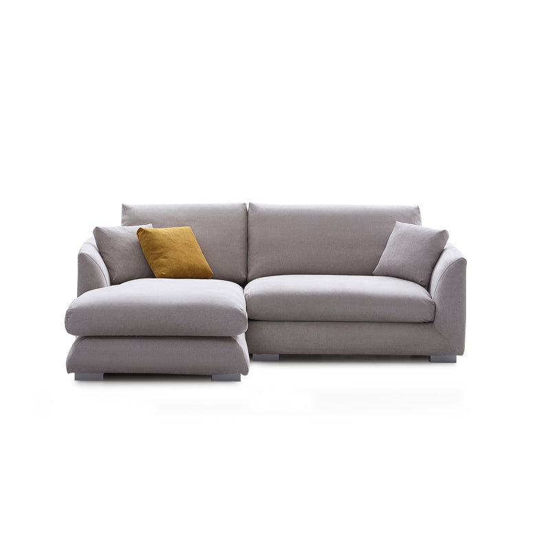 The Feathers 88" Left Facing Sectional is a modern grey sectional sofa featuring two large seat cushions and three matching grey cushions. To add a pop of color, there's a single mustard yellow cushion, all set against a white background.