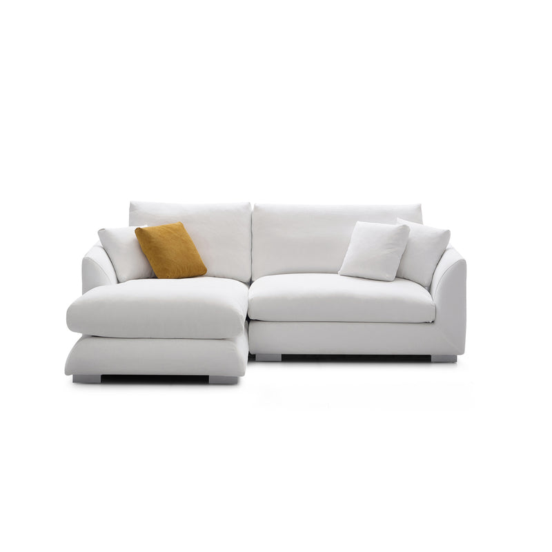 The Feathers 88" Left Facing Sectional is a contemporary L-shaped sofa in modern white, adorned with three matching white cushions and a contrasting brown cushion. Positioned against a plain white background, it elegantly showcases its clean lines and stylish design.