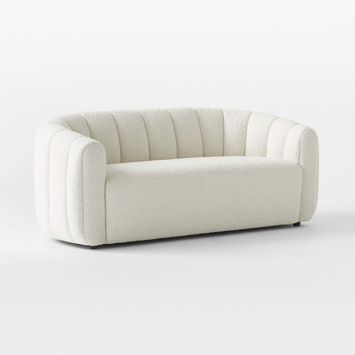 A plush loveseat with a smooth, curved back and armrests, upholstered in soft channeled green velvet. The Fitz 72.5" loveseat features a modern design and sits on a flat surface against a plain background.