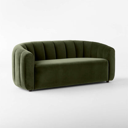 The Fitz 72.5" Channeled Green Velvet Loveseat features a plush and seamless cushion, a curved backrest with vertical tufting, and is displayed against a plain white background, offering a contemporary design.