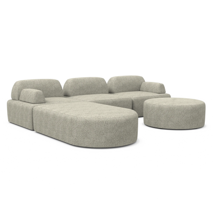 The Magna Preconfigured Sectional is showcased on a white background, boasting a modular gray fabric design with a large L-shaped section and a rounded ottoman. It features a minimalist style with smooth edges and no visible legs.