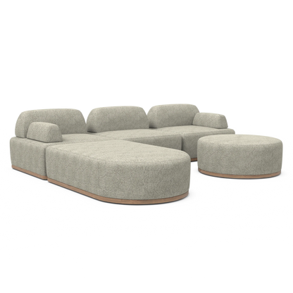 The Magna Preconfigured Sectional is a beige modular sofa with rounded sections and a matching round ottoman, featuring wooden bases. Its design is contemporary and minimalist, set against a white background.