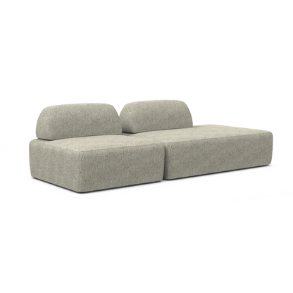 The Magna Preconfigured Sectional is a contemporary modular sofa in textured gray fabric, featuring two separate back cushions and a low-profile, block-style design that exudes a minimalist and modern aesthetic.