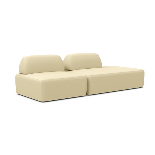 The Magna Preconfigured Sectional is a beige modular sofa that features two sections and two backrests. Its fabric is soft and modern, crafted for comfort and style in a contemporary living space.