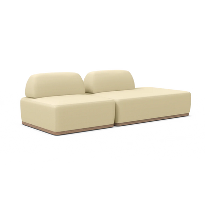 The Magna Preconfigured Sectional is a minimalist, modern beige couch featuring two backrests on a wooden base. It consists of two sections, offering a sleek and contemporary appearance.