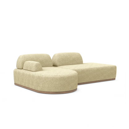 Introducing the Magna Preconfigured Sectional: a modern beige modular sofa featuring plush cushions and a low backrest. Its design includes rounded edges and a wooden base, providing a contemporary and comfortable seating option.