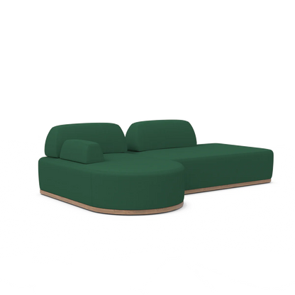 Introducing the Magna Preconfigured Sectional: a sleek sectional sofa in a vibrant green, featuring a minimalist design set against a white background. This contemporary piece includes smooth, rounded edges and is composed of two main sections—one with a comfortable backrest and the other extending into an elegant chaise lounge.