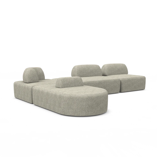 The Magna Preconfigured Sectional is a modular sofa set in grey that showcases a rounded, minimalist design. It consists of multiple sections, including two low-rise backrests and separate cushion pieces arranged on a white background.