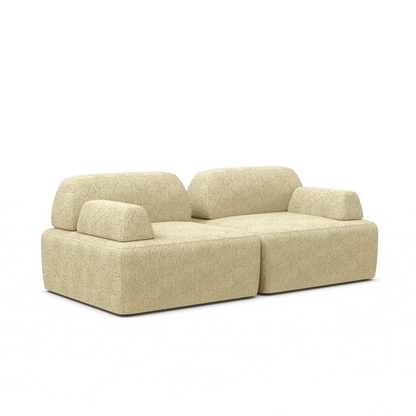 Introducing the Magna Preconfigured Sectional: a contemporary modular sofa in beige with two connected seats and removable cushions. It features blocky, minimalist lines and a textured fabric finish, providing both style and comfort against a plain background.