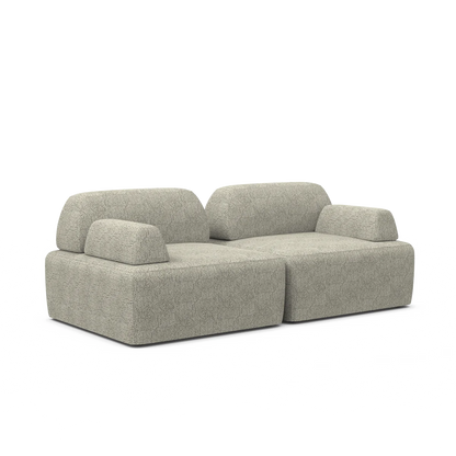 Introducing the Magna Preconfigured Sectional: a sleek and contemporary gray fabric sofa with a modular design. It boasts two backrests and wide armrests on both sides, offering a plush, textured look, all set against a simple white backdrop.