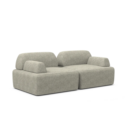 Introducing the Magna Preconfigured Sectional: a sleek and contemporary gray fabric sofa with a modular design. It boasts two backrests and wide armrests on both sides, offering a plush, textured look, all set against a simple white backdrop.