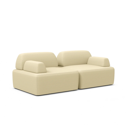 The Magna Preconfigured Sectional is a contemporary, beige sofa featuring plush cushions and a minimalist design, complete with armrests and two connected seating sections, all showcased against a white background.